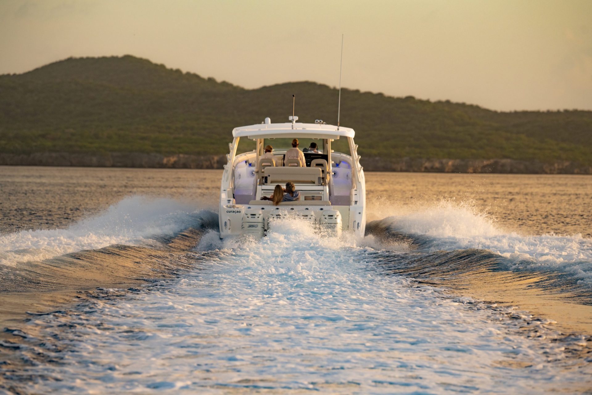 A yacht driving away from the camera