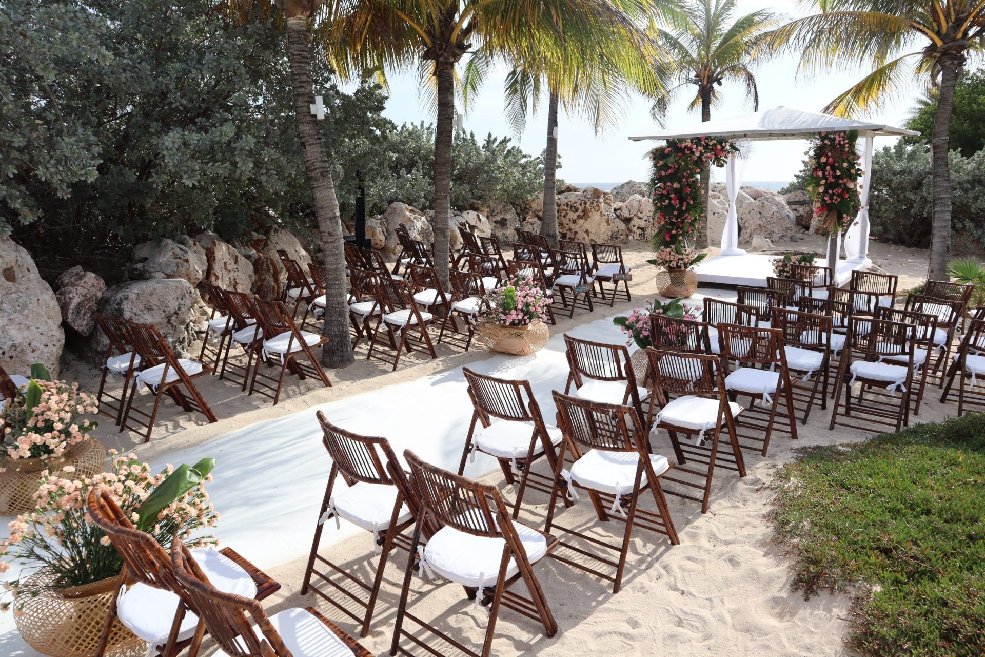 Beach area at Baoase set-up for a wedding with a wedding pergola, chairs and decoration